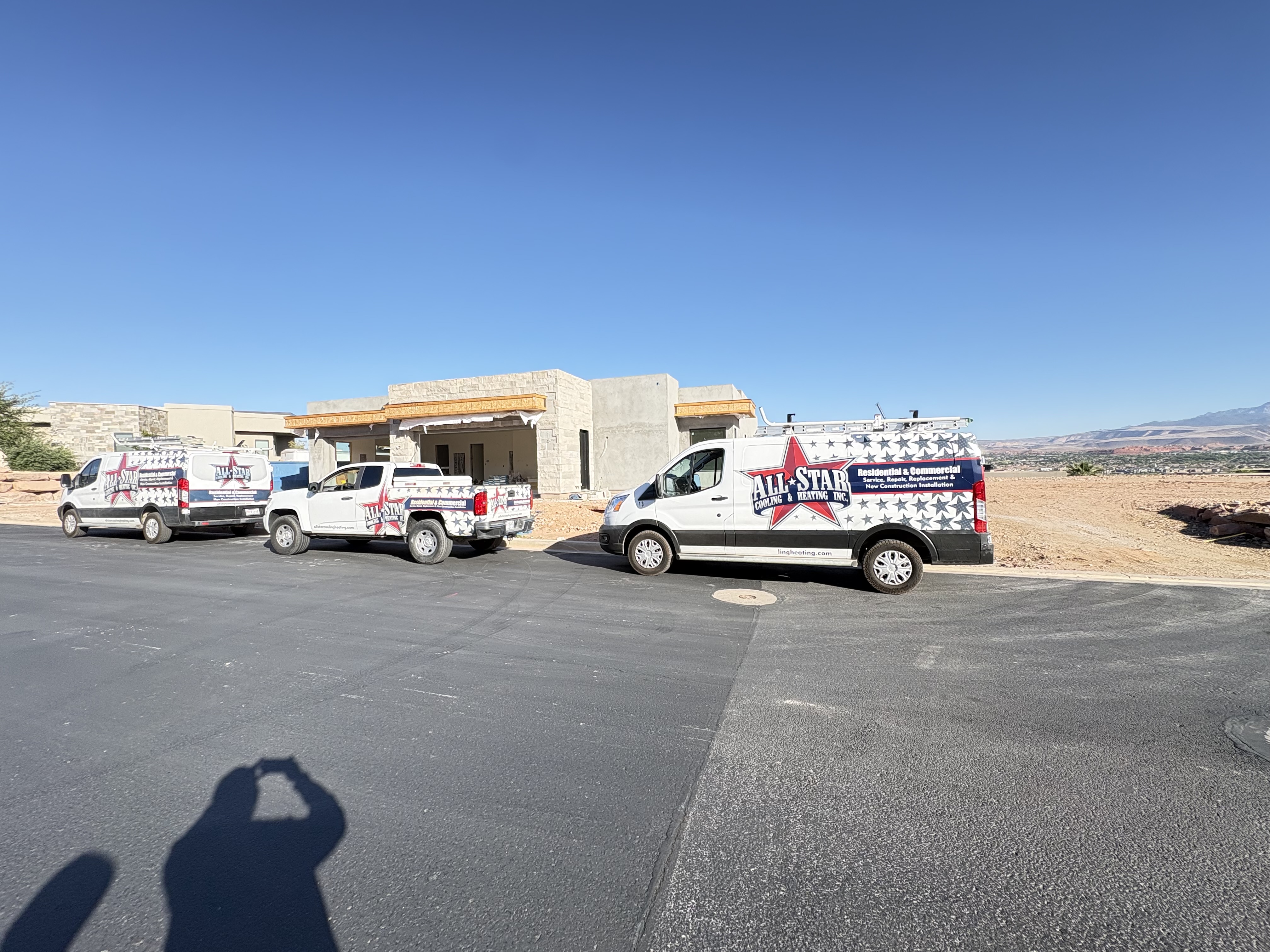 All Star Cooling & Heating service van and trucks parked at a residential job site in Southern Utah
