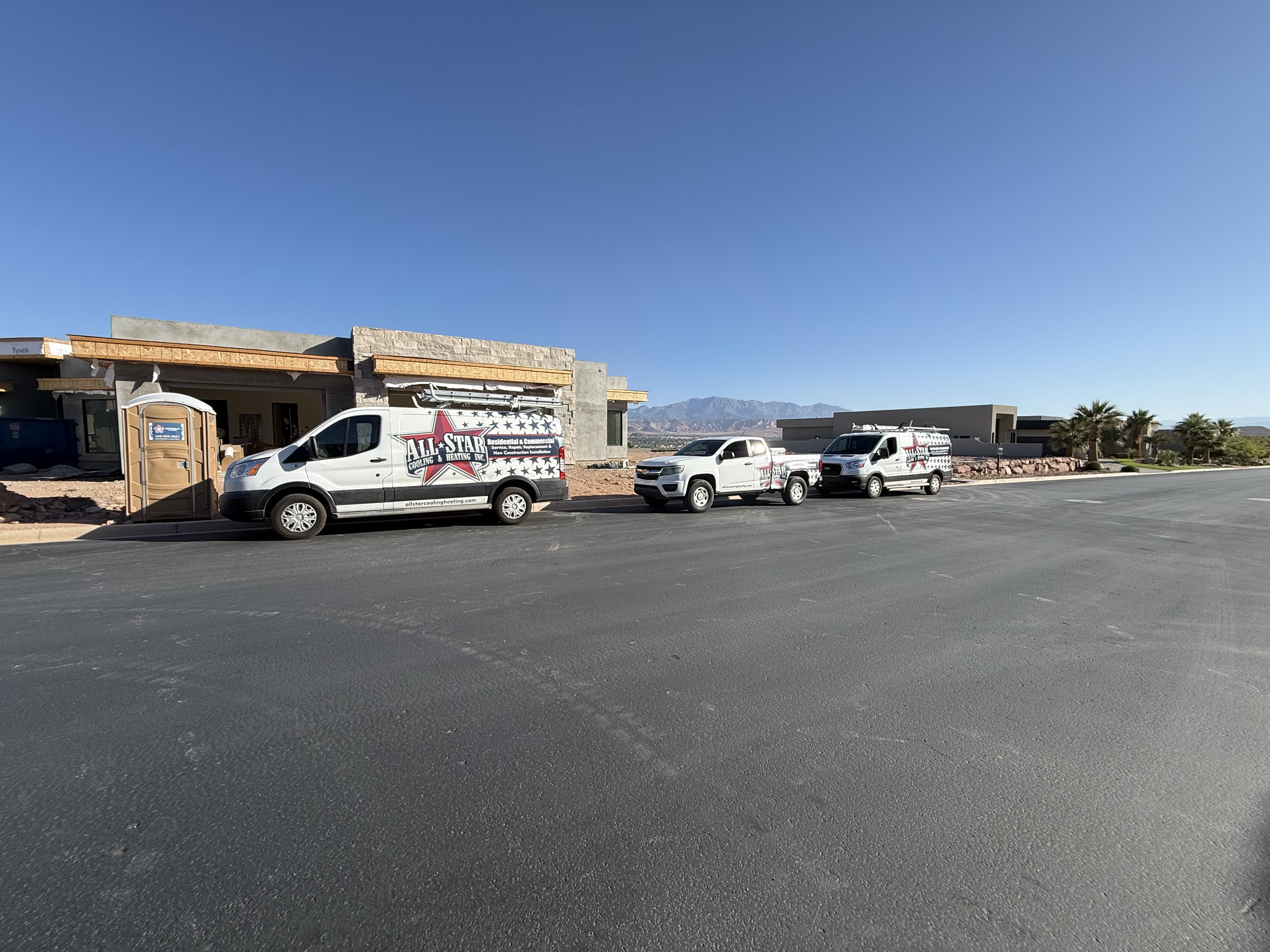 Three All Star Cooling & Heating vehicles parked at a new construction home in St. George, Utah