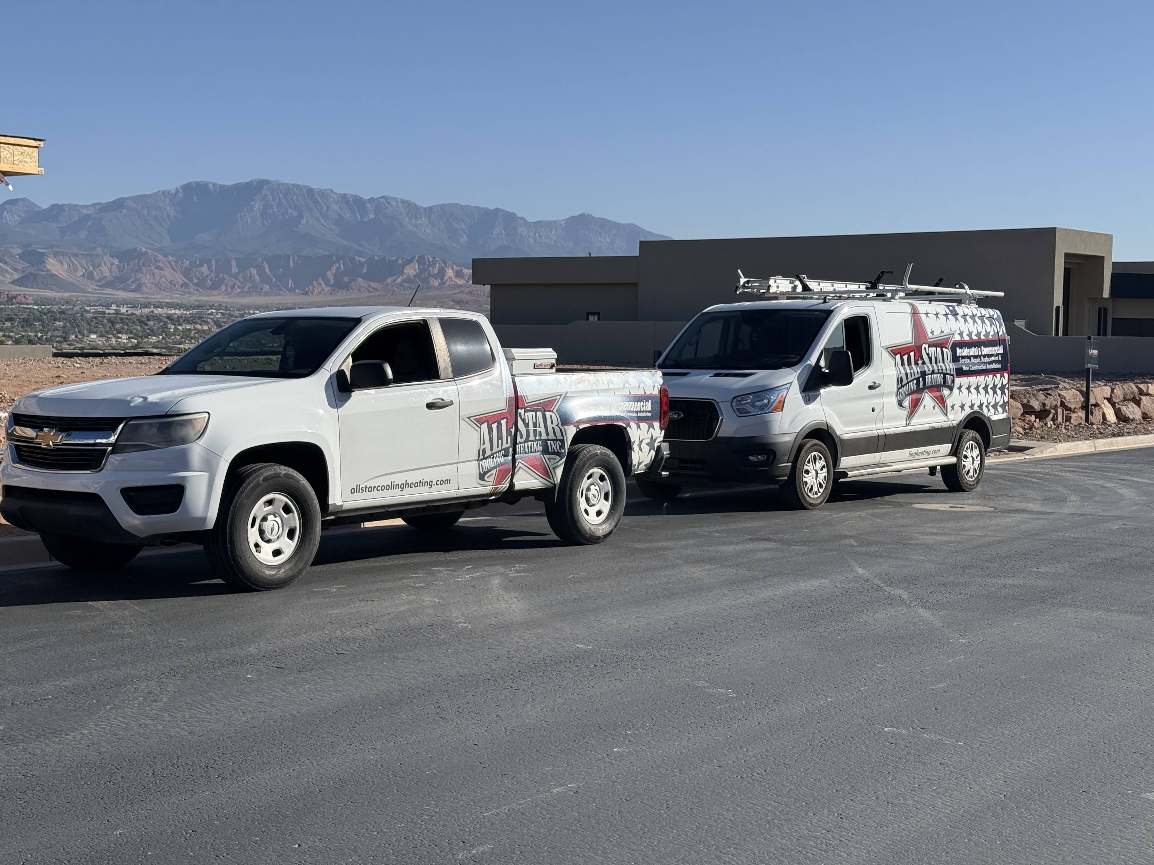 All Star Cooling & Heating branded pickup truck and service van with red rock mountains in the background